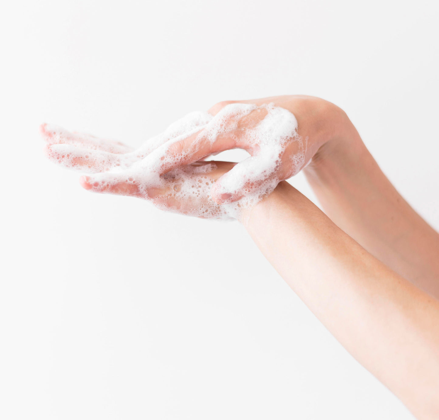 A woman washes her hand with the Magnolia Hand Wash.