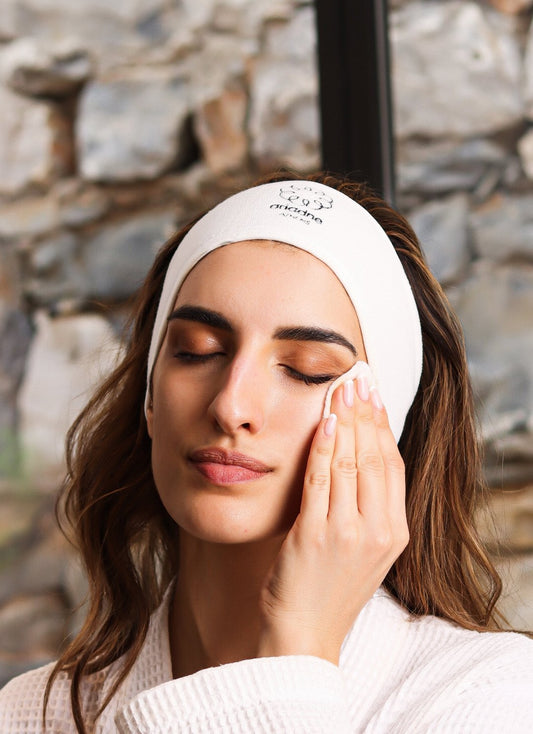 A woman applying on her face the Angel Face Cleansing Milk.